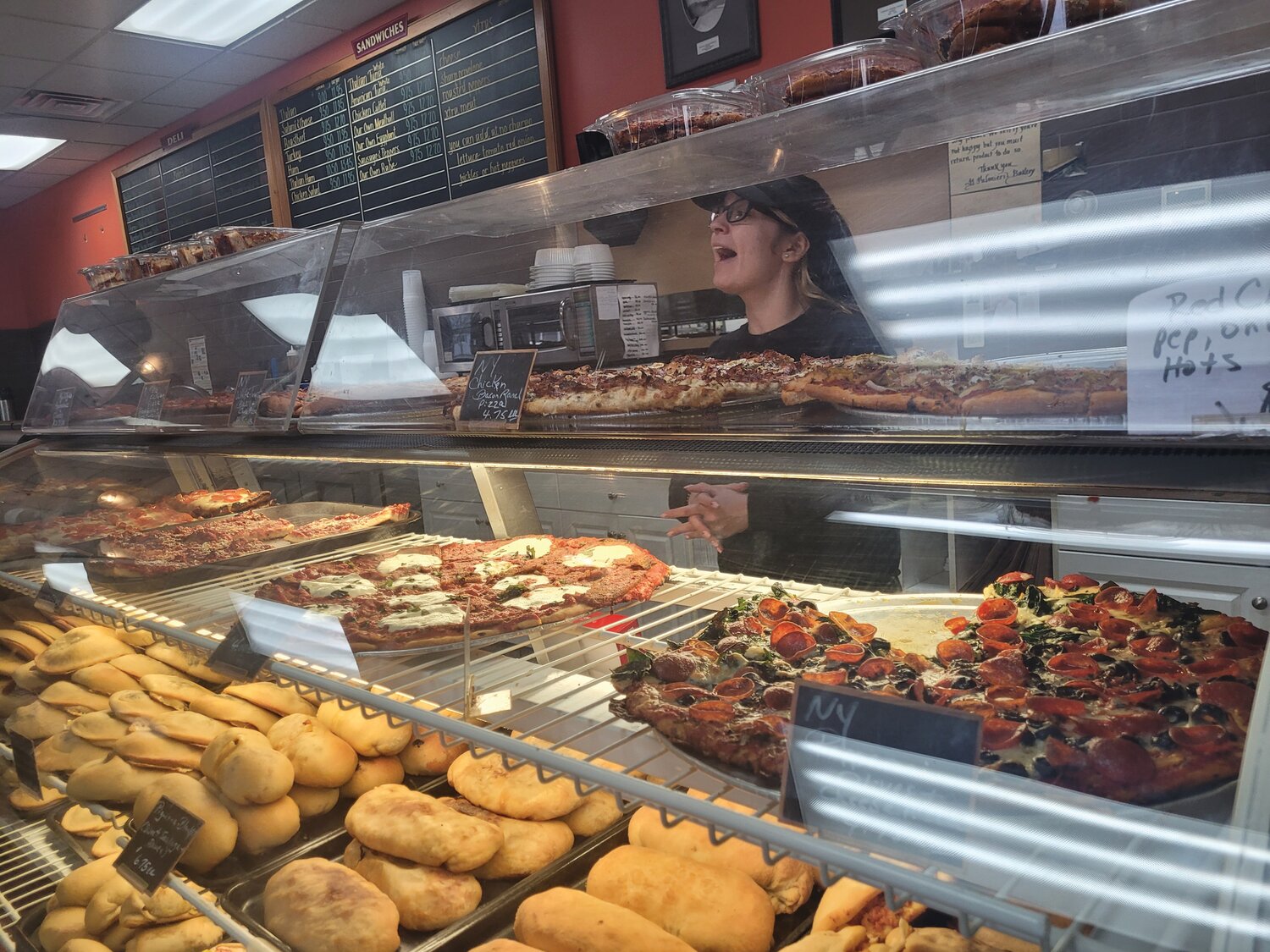 SERVICE WITH A SMILE: D. Palmieri’s Bakery recently celebrated six decades on Killingly Street in Johnston. They serve all kinds of pizza (not just the cold, cheeseless stuff).